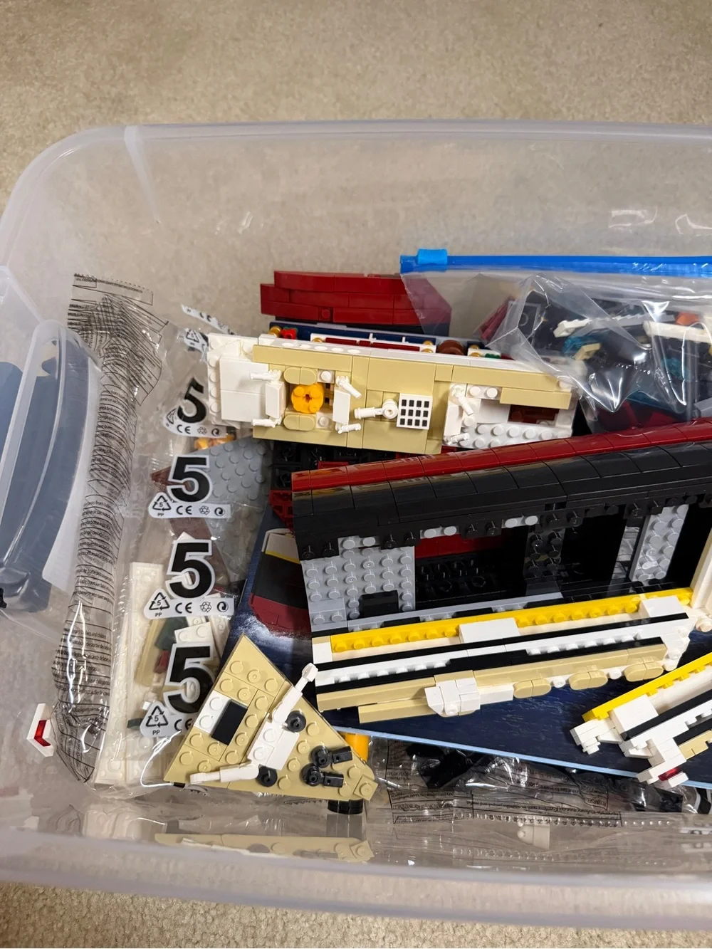 Assorted Lego Ship Hull Pieces in Red, Black, White, Yellow, Tan